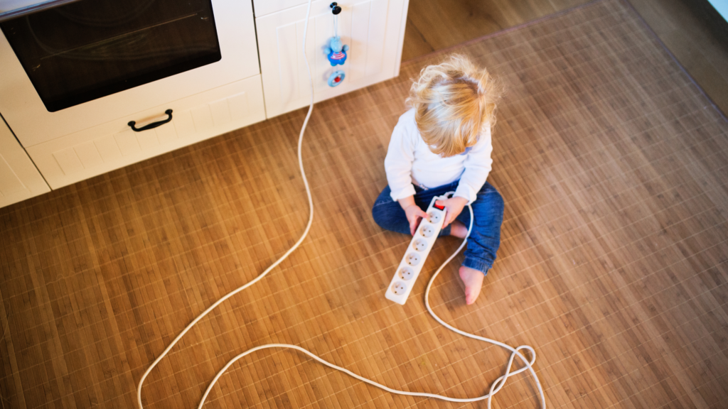 A child playing with a power bar, which is the opposite of Safety in the Kitchen