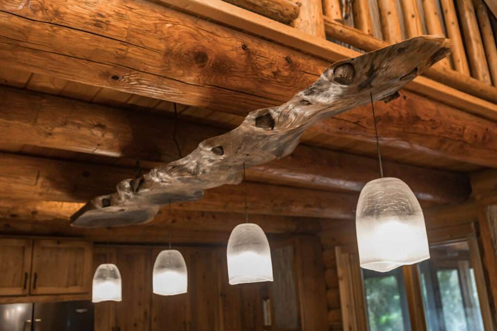 Boasting pendant lighting in log house kitchen