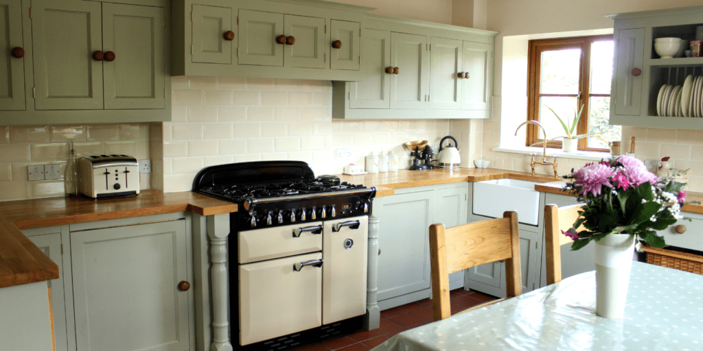 Angle view of sage green country kitchen
