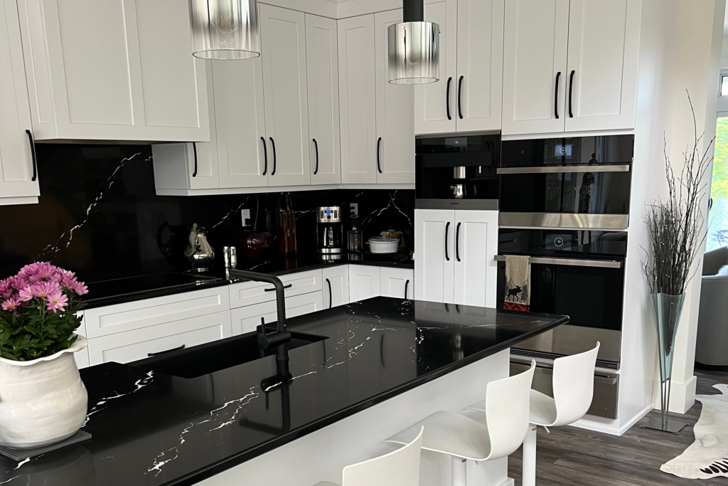white cabinets with black hardware and black countertops