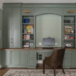 Moody deep-green office space in Maple and Walnut materials.