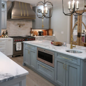 Cozy kitchen in white and light-blue colour. Maple and Cherry cabinets.