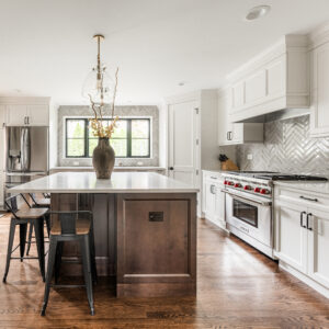 Great combination of white and deep brown cabinets make this kitchen warm and inviting
